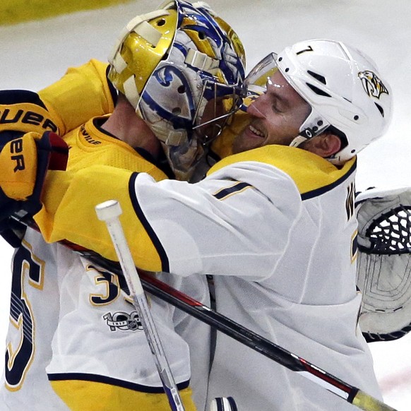 Nashville Predators goalie Pekka Rinne, left, celebrates with defenseman Yannick Weber after the Predators defeated the Chicago Blackhawks 2-1 in an NHL hockey game Friday, Oct. 27, 2017, in Chicago.  ...