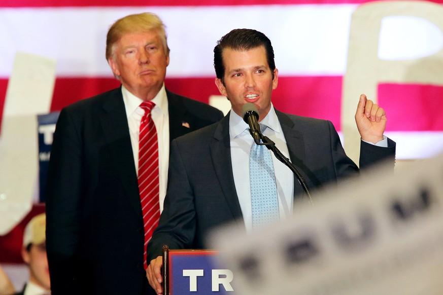 epa06082457 (FILE) - US Republican Presidential candidate Donald J. Trump (L) listens to his his son Donald Trump Jr. speaking to supporters during a rally at Lakefront Airport in New Orleans, Louisia ...