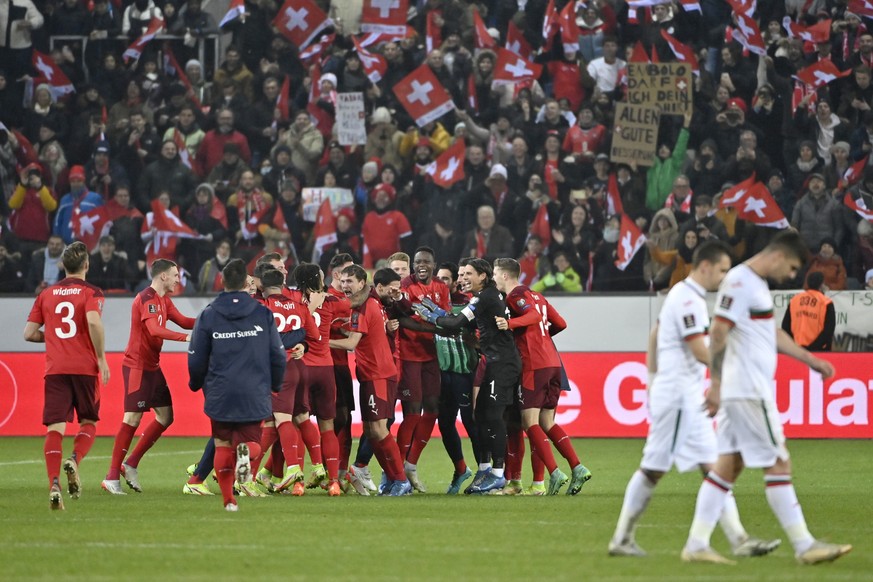 Switzerland's players celebrate after directly qualifying for the FIFA World Cup Qatar 2022 after the 2022 FIFA World Cup European Qualifying Group C match between Switzerland and Bulgaria at the ...