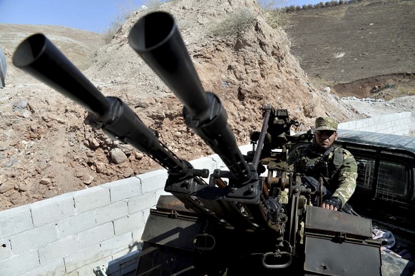 In this Sunday, Sept. 9, 2018 photo, fighters with the Free Syrian army patrol the outskirts of the northern town of Jisr al-Shughur, Syria, west of the city of Idlib. In the northern Idlib province,  ...