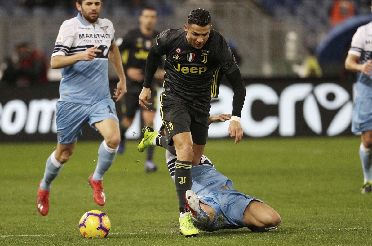 Juventus' Cristiano Ronaldo, top, is tackled by Lazio's Luis Alberto during the Serie A soccer match between Lazio and Juventus at the Olympic stadium, in Rome, Sunday, Jan. 27, 2019. (AP Ph ...
