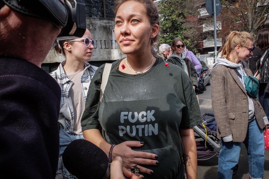 epa11225745 Media film as Russians living in Italy stand in a queue on the last day of voting for the Russian presidential elections, in front of the Russian consulate, in Milan, Italy, 17 March 2024. ...