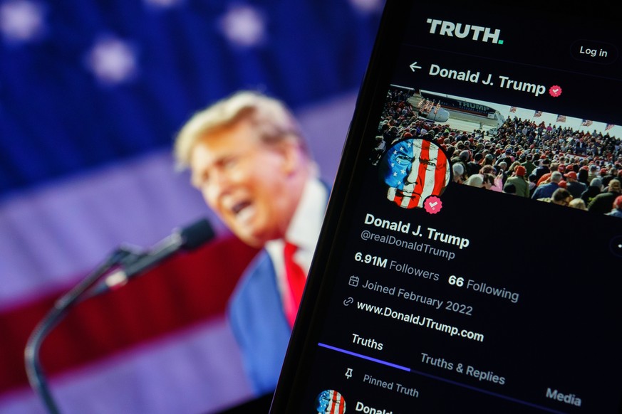 epa11255982 A photo illustration of former US President Donald Trump&#039;s account on social media platform Truth Social shown on a mobile phone in Washington, DC, USA, 02 April 2024. Stock in the pa ...