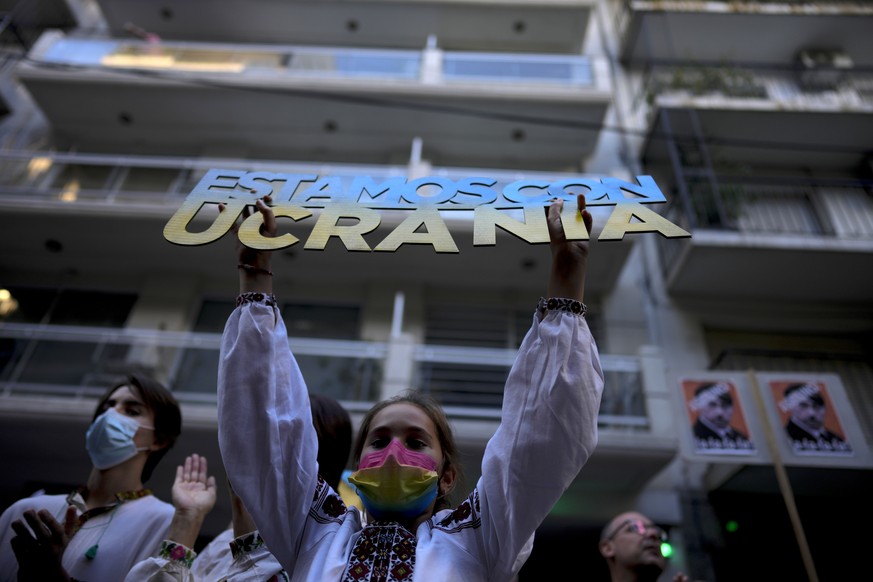 A girl holding a sign with a message that reads in Spanish: &quot;We are with Ukraine&quot;, during a protest outside the Russian embassy against Russia&#039;s invasion of the Ukraine, in Buenos Aires ...