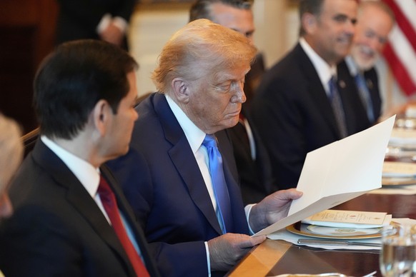 President Donald Trump looks at a document during a meeting with Israel&#039;s Prime Minister Benjamin Netanyahu in the Blue Room of the White House, Monday, July 7, 2025, in Washington. (AP Photo/Ale ...