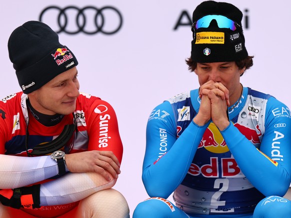 epa12677285 (L-R) Second placed Marco Odermatt of Switzerland, first placed Giovanni Franzoni of Italy and third placed Maxence Muzaton of France sit on the podium after the Men's Downhill race a ...