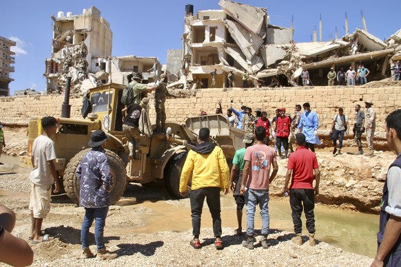 People look for survivors in Derna, Libya, Wednesday, Sept.13, 2023. Search teams are combing streets, wrecked buildings, and even the sea to look for bodies in Derna, where the collapse of two dams u ...