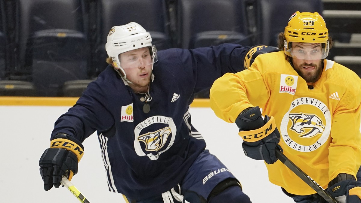 Nashville Predators defenseman Roman Josi (59) moves the puck ahead of center Rem Pitlick (16) during NHL hockey training camp Tuesday, Jan. 5, 2021, in Nashville, Tenn. Team captain Josi won the Norr ...
