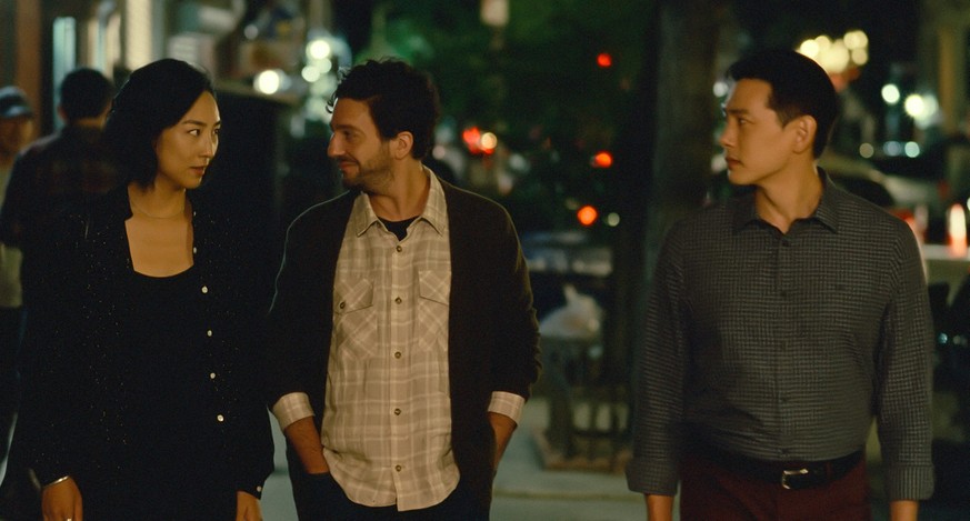 This image released by A24 shows Greta Lee, from left, John Magaro, Teo Yoo in a scene from &quot;Past Lives.&quot; (Jon Pack/A24 via AP)