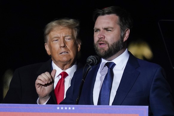 Ohio Senate candidate JD Vance speaks as former President Donald Trump listens at a campaign rally at Wright Bros. Aero Inc. at Dayton International Airport on Monday, Nov. 7, 2022, in Vandalia, Ohio. ...