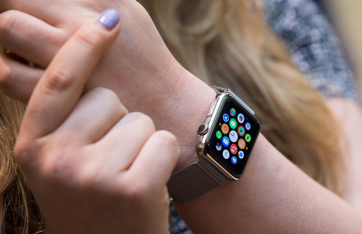epa04698246 A woman wears Apple's new watch during a preview day at the Apple Store in Covent Garden in London, Britain, 10 April 2015. Apple's latest offering went on display on 10 April in ...