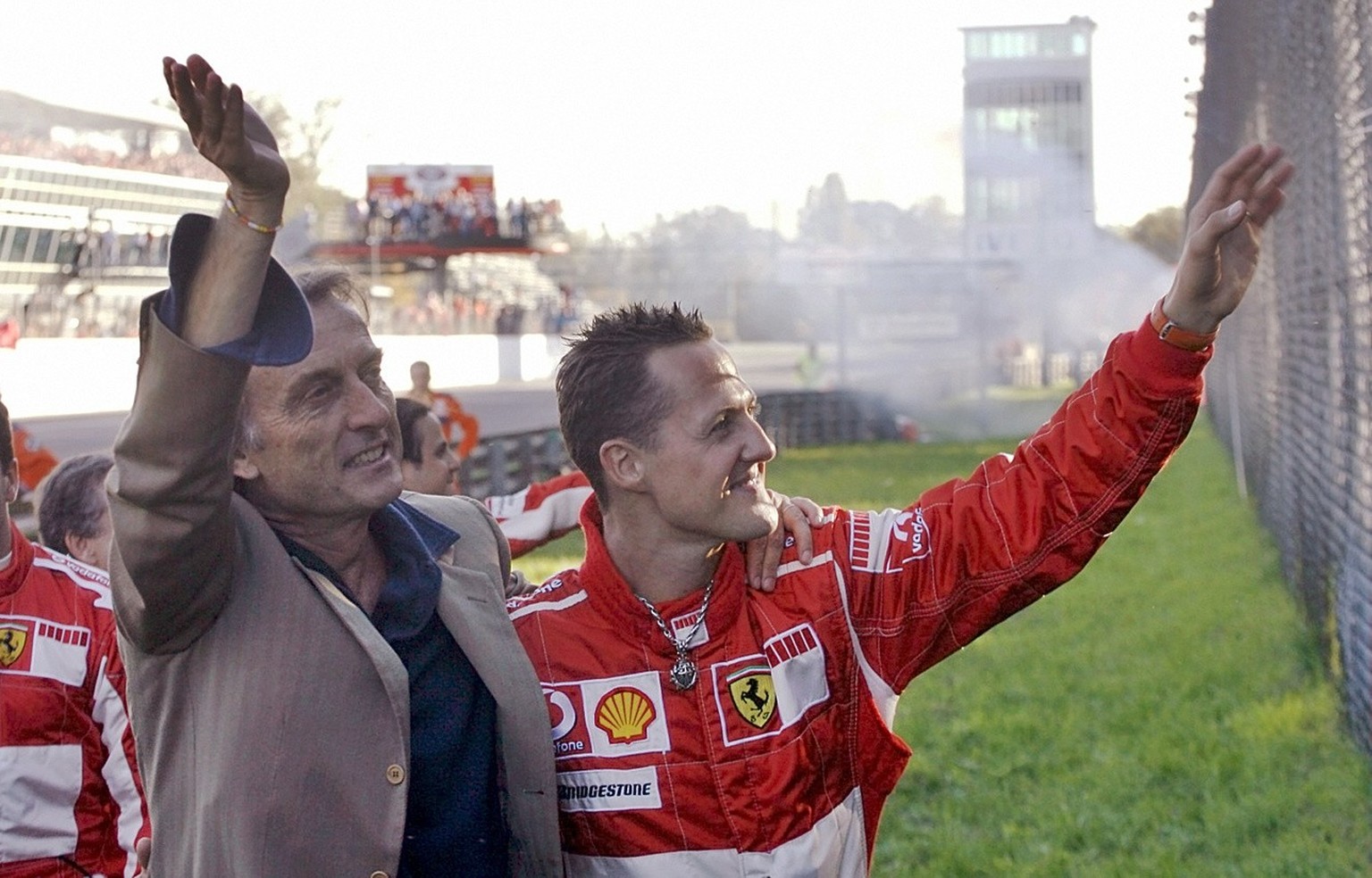 Germany&#039;s Michael Schumacher and Ferrari &#039;s president Luca Di Montezemolo, left, wave to Ferrari fans at the Monza racetrack, Italy, during the Ferrari World Finals, the racing team&#039;s t ...