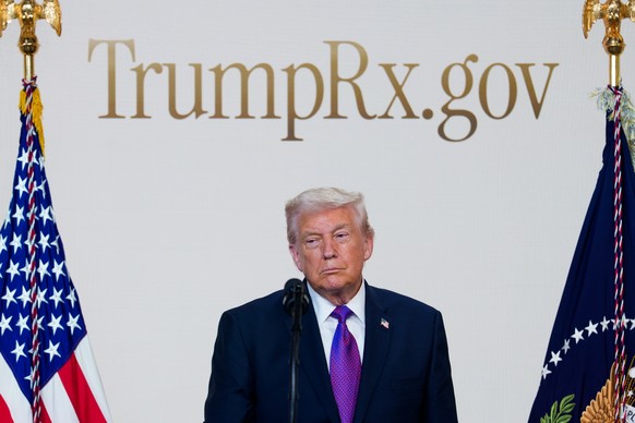 epa12707919 US President Donald J. Trump looks on during an event to present 'TrumpRx,' a website for consumers to purchase prescription drugs, in the South Court Auditorium of the Eisenhowe ...
