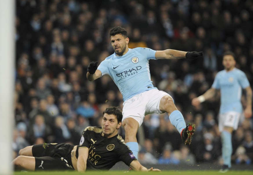 Manchester City&#039;s Sergio Aguero, center, scores his side&#039;s third goal during the English Premier League soccer match between Manchester City and Leicester City at the Etihad Stadium in Manch ...