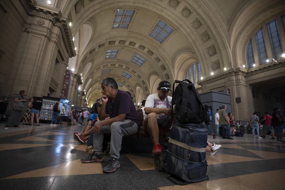 People wait for the train service to be restored following a major stoppage due to a power blackout, at Constitucion station in Buenos Aires, Argentina, Wednesday, March 1, 2023. Buenos Aires and seve ...