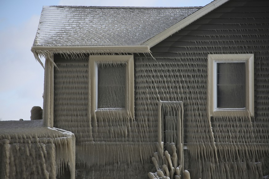 A house along Hoover Beach is covered by ice from high winds and from the waves from Lake Erie, Saturday, Feb. 29, 2020, in Hamburg N.Y. Blowing snow has fallen around the state since Thursday, though ...