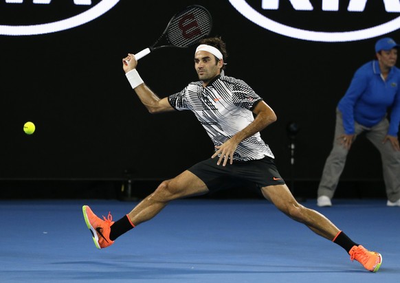 Switzerland&#039;s Roger Federer makes a forehand return to Austria&#039;s Jurgen Melzer during their first round match at the Australian Open tennis championships in Melbourne, Australia, Monday, Jan ...