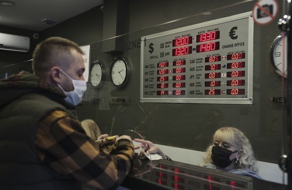 A man changes Turkish lira for USD and Euro at a currency exchange shop, in Ankara, Turkey, Tuesday, Nov. 23, 2021. The Turkish currency weakened by nearly 10% against the U.S. dollar Tuesday, a day a ...