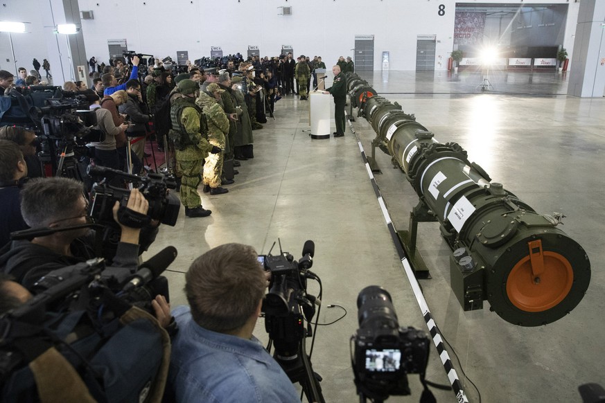 Foreign military attaches and journalists attend a briefing by the Russian Defense Ministry as the 9M729 land-based cruise missile, right, in Kubinka outside Moscow, Russia, Wednesday, Jan. 23, 2019.  ...