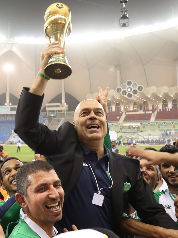 epa04618567 Al-Ahli coach Christian Gross celebrates with the trophy after winning the Crown Prince Cup final soccer match against Al Hilal at the King Fahd International Stadium in Riyadh, Saudi Arab ...