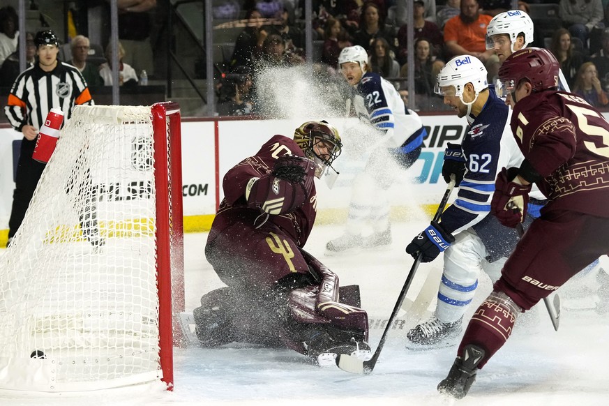 Winnipeg Jets right wing Nino Niederreiter (62) scores a goal against Arizona Coyotes goaltender Karel Vejmelka, left, as Coyotes defenseman Troy Stecher, right, Jets defenseman Ville Heinola, back ri ...