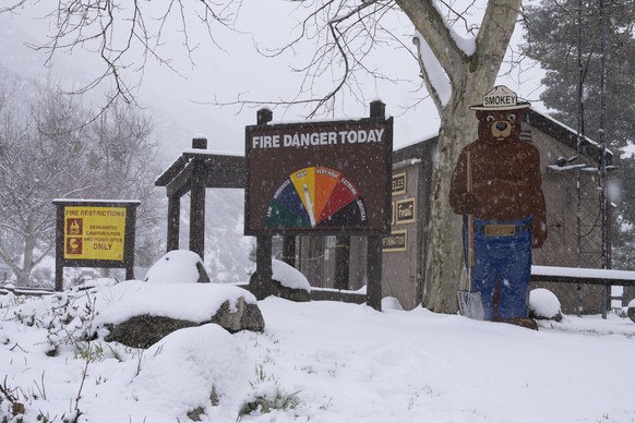 Snow piles up around a Fire Danger Today sign in the Angeles National Forest near La Canada Flintridge, Calif., Thursday, Feb. 23, 2023. For the first time since 1989, the National Weather Service iss ...