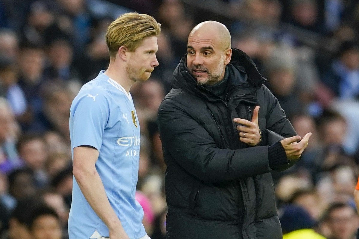 Manchester City's head coach Pep Guardiola, right, gives instructions to Manchester City's Kevin De Bruyne during the English FA Cup third round soccer match between Manchester City and Hudd ...