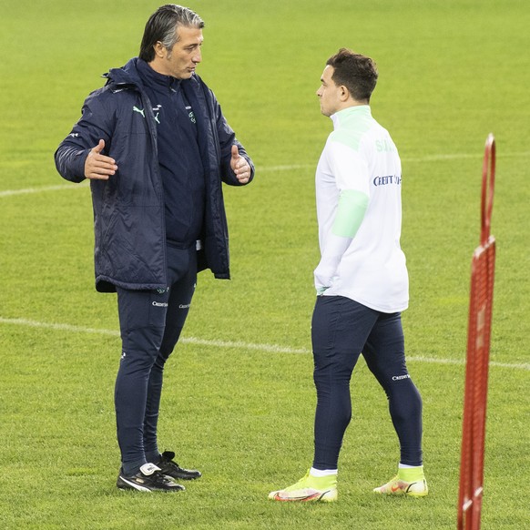 Switzerland&#039;s head coach Murat Yakin, left, speaks with Xherdan Shaqiri during a training session the day before the 2022 FIFA World Cup European Qualifying Group C soccer match between Switzerla ...