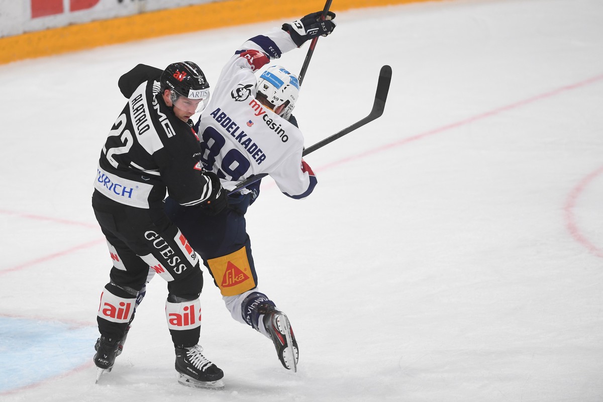 Lugano?s player Santeri Alatalo, left, fights for the puck with Zug's player Justin Abdelkader, right, during the preliminary round game of National League Swiss Championship 2022/23 between HC L ...
