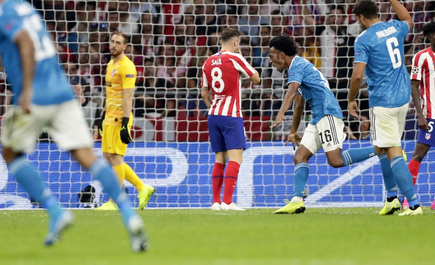 Juventus&#039; Juan Cuadrado celebrates scoring the opening goal during the Champions League Group D soccer match between Atletico Madrid and Juventus at Wanda Metropolitano stadium in Madrid, Spain,  ...