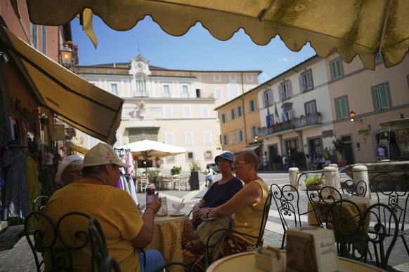 Customers enjoy drinks in the town of Castel Gandolfo, a historic summer retreat for popes about 30 kilometers southeast of Rome, where Pope Leo XIV will be spending a short period of rest, as seen We ...