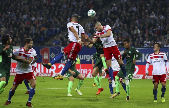 Hamburg&#039;s Kyriakos Papadopoulos, centre, heads the ball out of the penalty area during the German Bundesliga soccer match between Hamburger SV and Werder Bremen in Hamburg, Germany, Saturday, Sep ...
