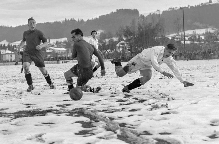 Der FC St. Gallen, dunkles Dress, verliert das Spiel der Schweizermeisterschaft auf schneebedecktem Terrain gegen den FC La Chaux-de-Fonds, helles Dress, mit 2:5, aufgenommen im November 1944 in St. G ...