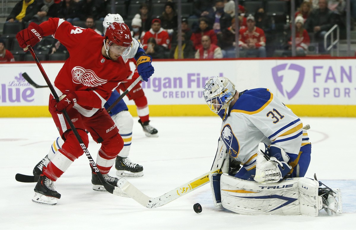 Buffalo Sabres goaltender Dustin Tokarski (31) deflects a shot by Detroit Red Wings center Pius Suter (24) during the first period of an NHL hockey game Saturday, Nov. 27, 2021, in Detroit. (AP Photo/ ...