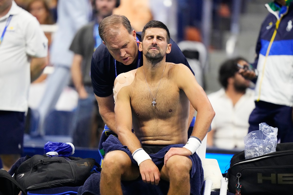 Novak Djokovic, of Serbia, gets medical treatment during the first round of the U.S. Open tennis championships against Mariano Navone, of Argentina, Sunday, Aug. 30, 2026, in New York. (AP Photo/Frank ...
