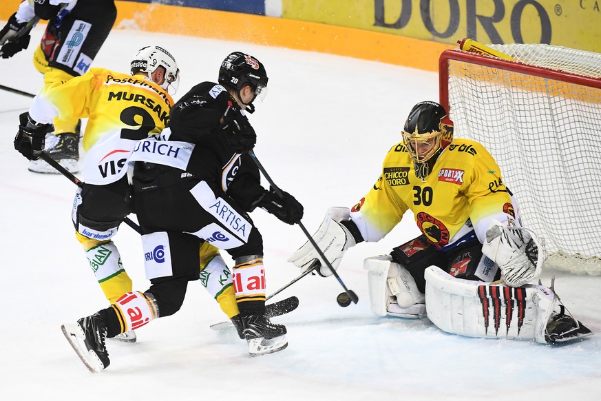 Bern&#039;s player Jan Mursak, Lugano&#039;s player Henrik Haapala and Bern&#039;s goalkeeper Leonardo Genoni, from left, during the preliminary round game of National League Swiss Championship 2018/1 ...