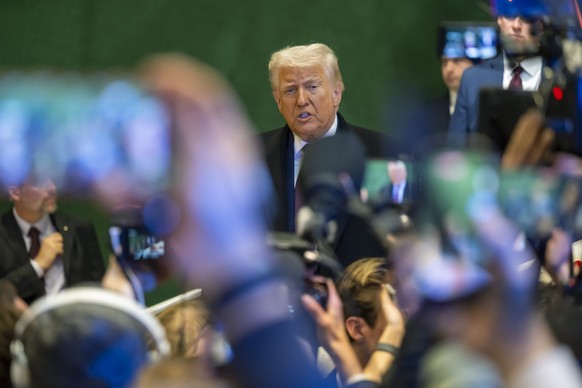 epa12671131 US President Donald Trump answers journalists' questions before leaving at the Annual Meeting of the World Economic Forum (WEF), in Davos, Switzerland, 22 January 2026. The 2026 summi ...