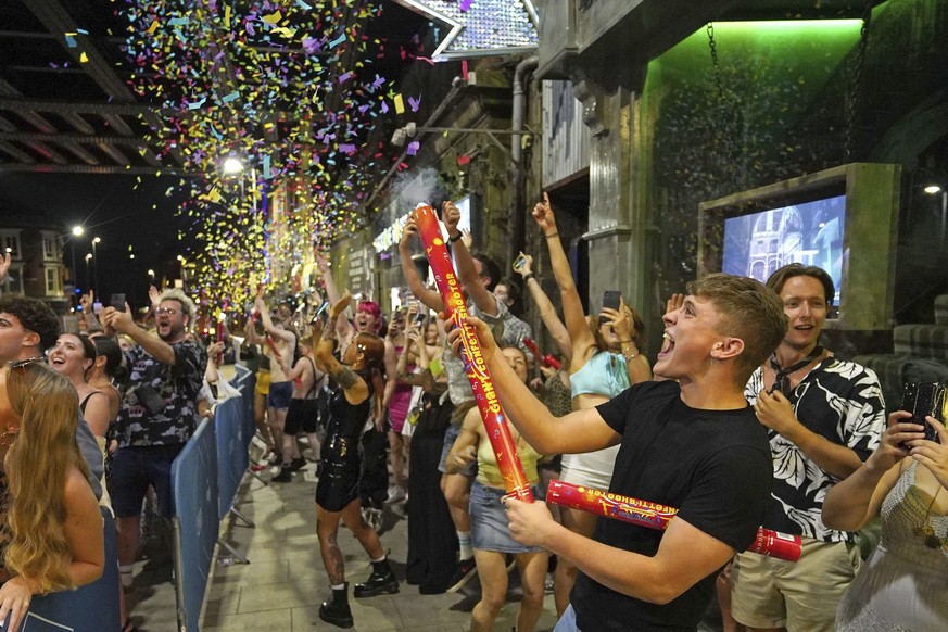 People celebrate as they queue up for entry at the Viaduct Bar in Leeds, after the final legal coronavirus restrictions were lifted in England at midnight, Monday, July 19, 2021. (Ioannis Alexopoulos/ ...