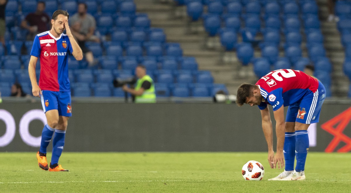 Basel's Luca Zuffi, left, and Albian Ajeti, right, react during the UEFA Champions League second qualifying round second leg match between Switzerland's FC Basel 1893 and Greece's PAOK  ...