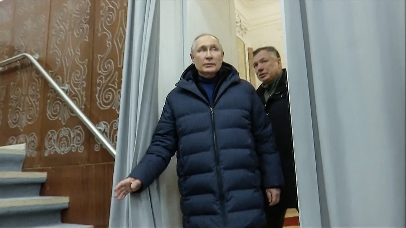 In this photo taken from a video released by Russian TV Pool on Sunday, March 19, 2023, Russian President Vladimir Putin, accompanied by Russian Deputy Prime Minister Marat Khusnullin, visits the Mariupol t...