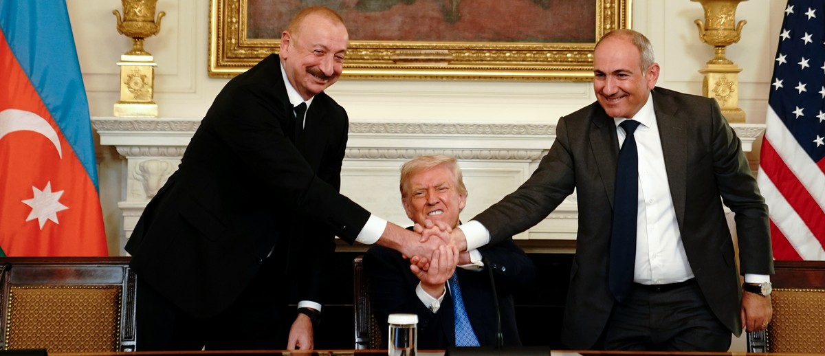 epa12290502 (L-R) Azerbaijan's President Ilham Aliyev, US President Donald Trump, and Armenia's Prime Minister Nikol Pashinyan join hands during a signing ceremony in the State Dining Room o ...