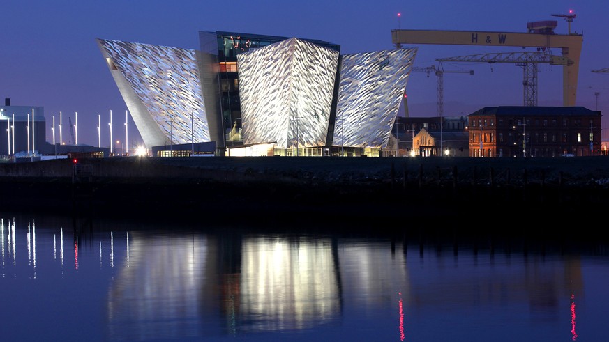 FILE - In this March 25 2012, file photo, the Titanic House Visitor Centre is reflected on Belfast Lough, Northern Ireland. The area surrounding the defunct shipyard where the doomed Titanic cruise sh ...