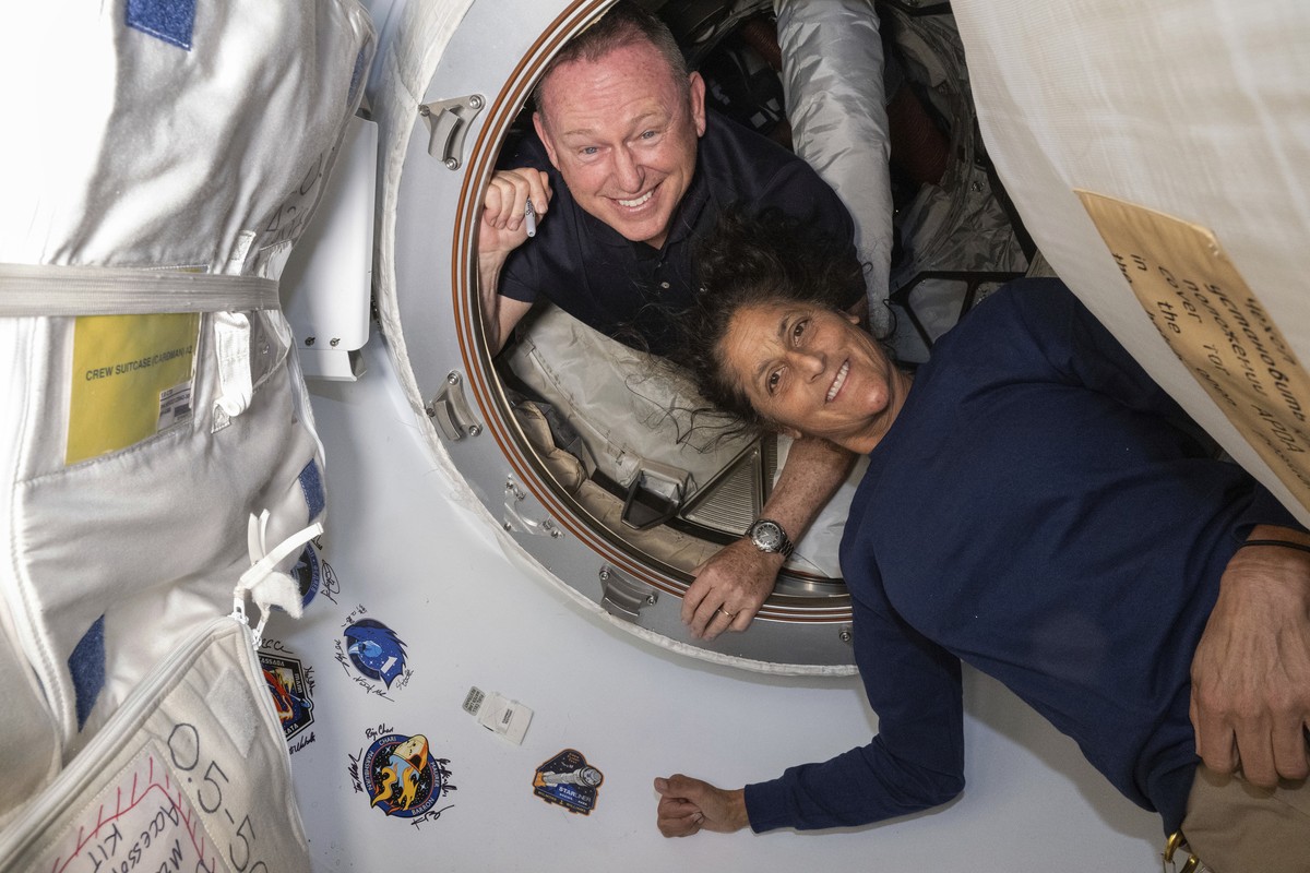FILE - In this photo provided by NASA, Boeing Crew Flight Test astronauts Butch Wilmore, left, and Suni Williams pose for a portrait inside the vestibule between the forward port on the International  ...