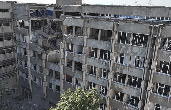 epa10076282 A handout photo made available by the press service of the State Emergency Service of Ukraine shows a damaged building after a shelling in Mykolaiv, Ukraine, 17 July 2022. According to Myk ...