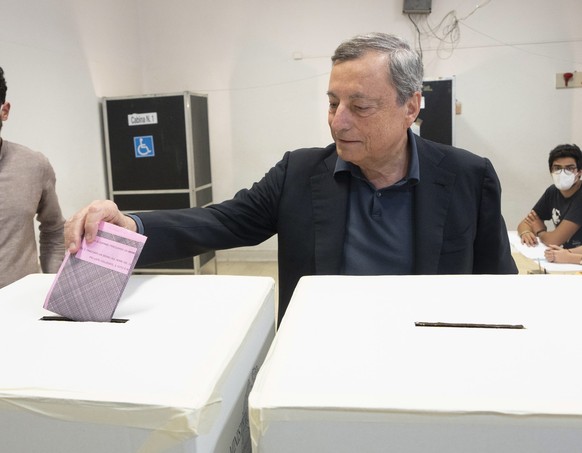 epa10205843 A handout photo made available by Chigi Palace Press Office shows Italian Prime Minister, Mario Draghi, during voting operations in the Italian general election at a polling station in Rom ...