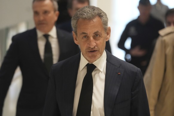 FILE - Former French President Nicolas Sarkozy arrives as he goes on trial over alleged illegal financing of his 2007 presidential campaign by the government of late Libyan leader Moammar Gadhafi, Mon ...