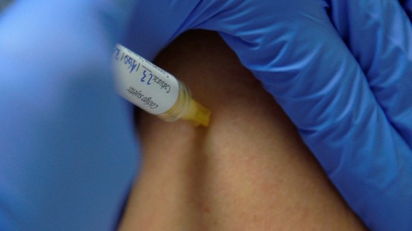 epa09431989 An undated handout photo made available by the Hospital Clinic Barcelona on 27 August 2021 shows a health worker inoculating the Spanish vaccine &#039;Hipra&#039; to a volunteer in Barcelo ...