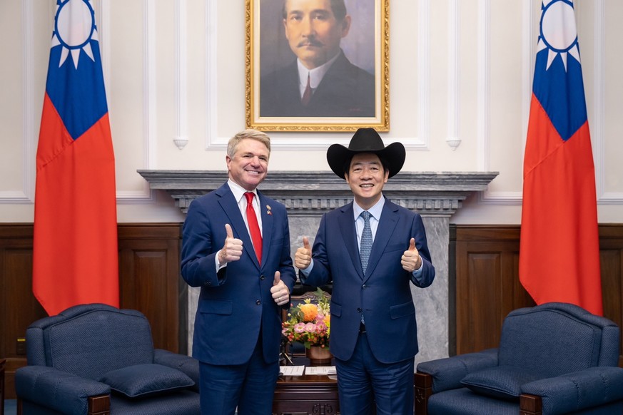 epa11372854 A handout photo made available by the Taiwan Presidential office shows Taiwan President William Lai (R) posing for a photograph with United States Representative Michael McCaul (L) during  ...
