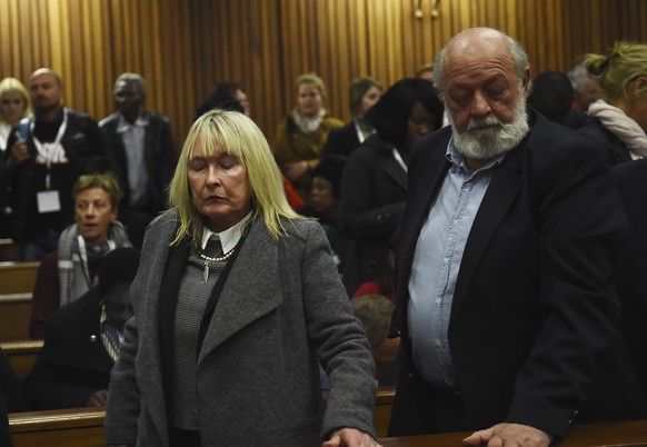 FILE �?? The parents of the late Reeve Steenkamp, June, left, and Barry Steenkamp, right, leave the High Court in Pretoria, South Africa, Wednesday, July 6, 2016. Eight years after he shot dead his gi ...