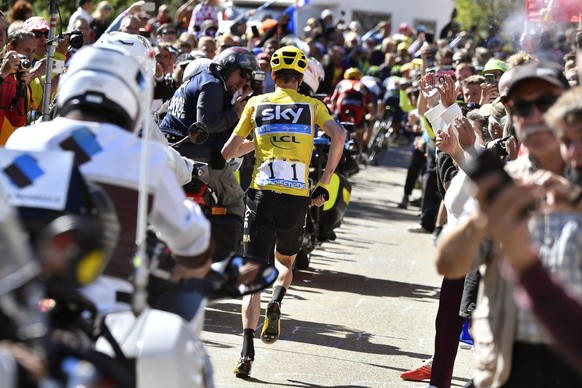 epa05424652 British rider Christopher Froome (C) of Team Sky runs without his bicycle after crashing into during the 12th stage of the 103rd edition of the Tour de France cycling race over 178km betwe ...